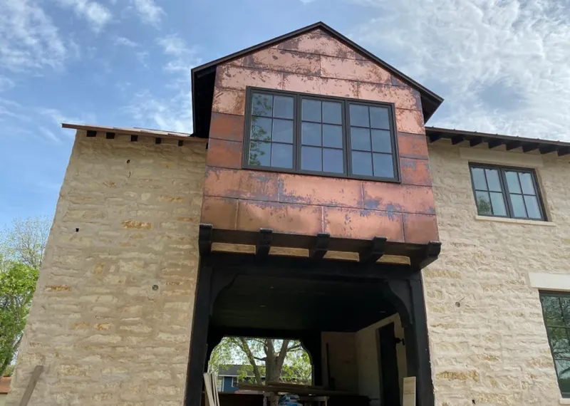 Copper metal panel facade on a stone building for Roof Repair in Clarksville
